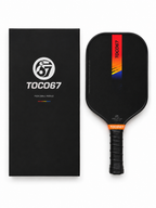 TOCO67 black carbon fiber pickleball paddle with colorful graphic design and matching box.