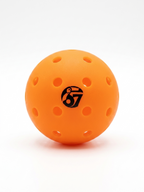 Orange perforated pickleball with 67 logo on a white background