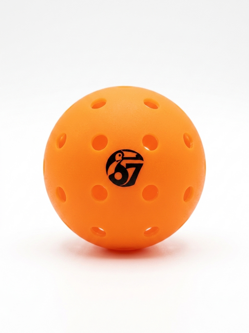 Orange perforated pickleball with 67 logo on a white background