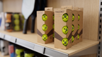 TOCO67 yellow 3-pack competition pickleballs on a retail shelf.