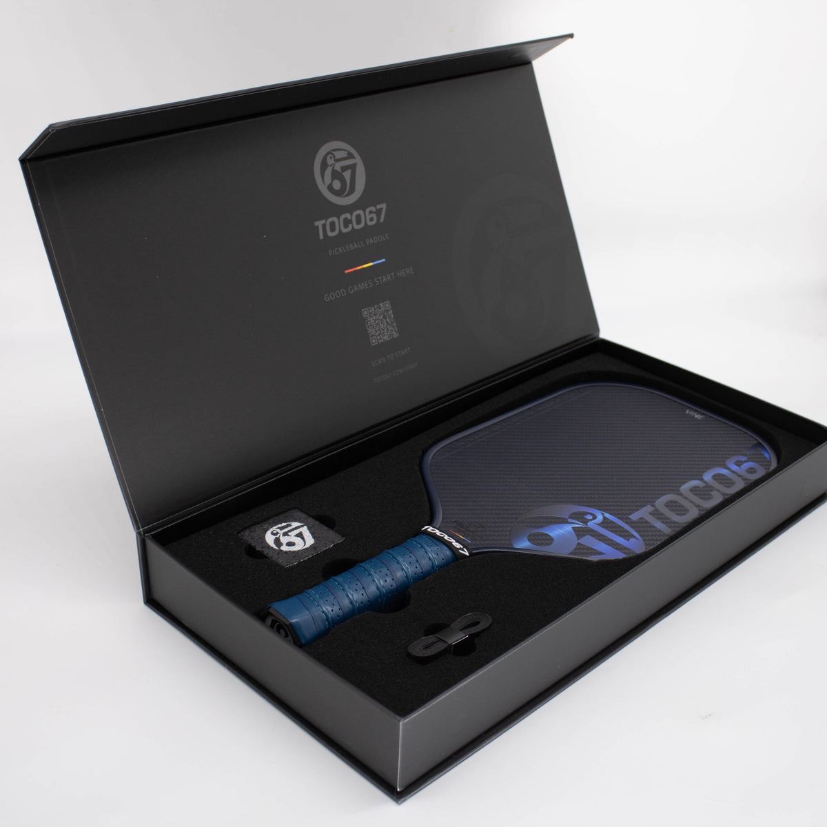 TOCO67 pickleball paddle in a premium black gift box with accessories.